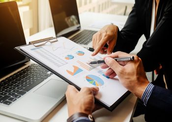 workplace-results-professional-report-accounting-during Business concept. Business people discussing the charts and graphs showing the results of their successful teamwork. Selective focus.